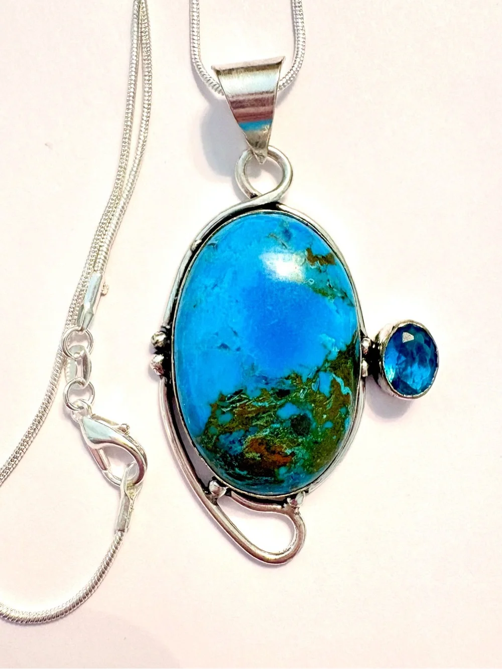 2 1/2 inch, 925 marked, Turquoise and Blue Topaz pendant on a silver chain.